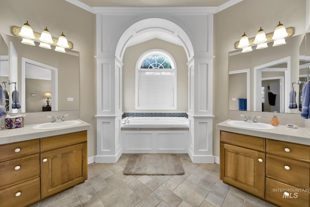 bathroom featuring a sink, decorative columns, and two vanities