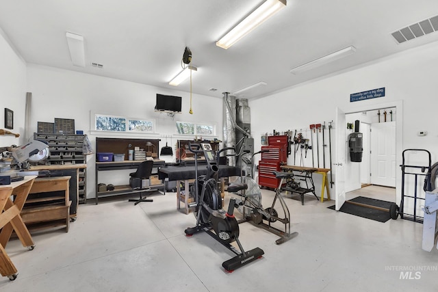 workout area with visible vents and a workshop area