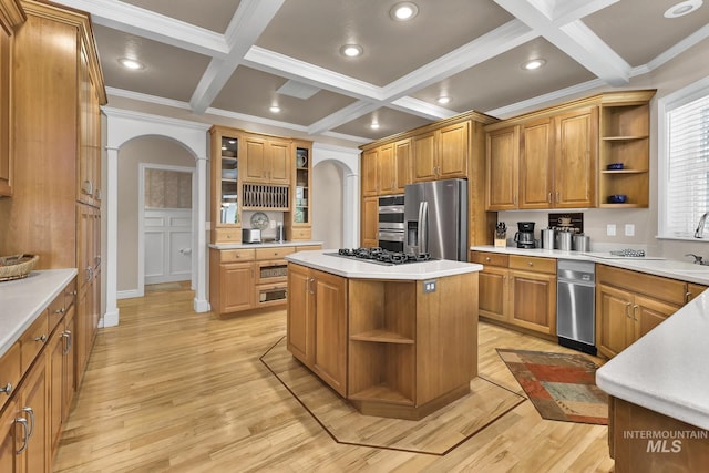 kitchen with open shelves, coffered ceiling, arched walkways, and stainless steel appliances