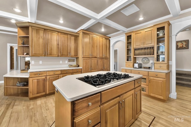 kitchen with open shelves, arched walkways, ornamental molding, and black gas stovetop