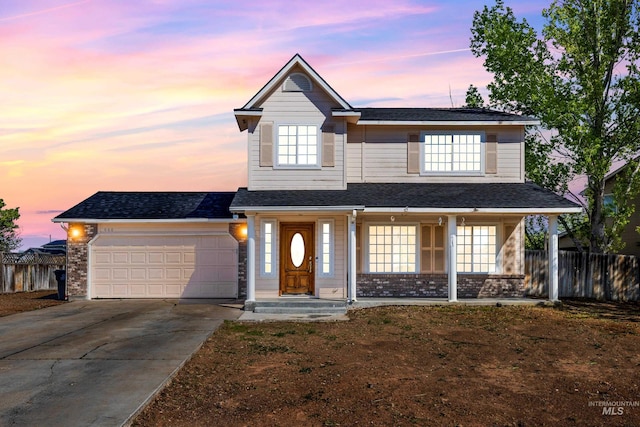 660 Teton, Mountain Home, ID 83647 - traditional-style house featuring fence, an attached garage, concrete driveway, a porch, and roof with shingles