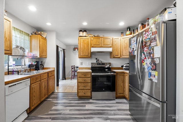 660 Teton, Mountain Home, ID 83647 - kitchen featuring under cabinet range hood, light countertops, stainless steel appliances, and a sink