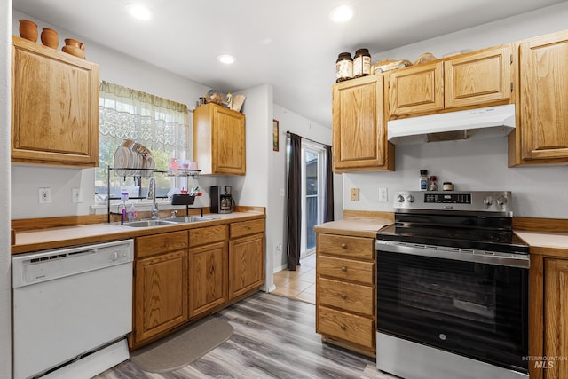 660 Teton, Mountain Home, ID 83647 - kitchen with a sink, stainless steel electric range, under cabinet range hood, light countertops, and white dishwasher