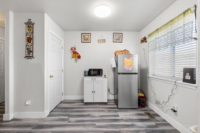 660 Teton, Mountain Home, ID 83647 - clothes washing area with baseboards and wood finished floors