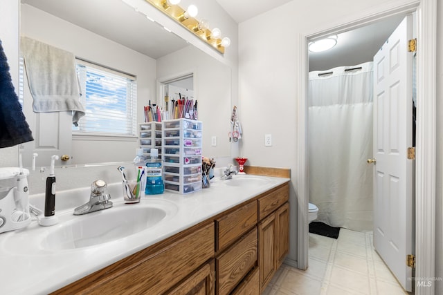 660 Teton, Mountain Home, ID 83647 - bathroom with tile patterned floors, double vanity, toilet, and a sink