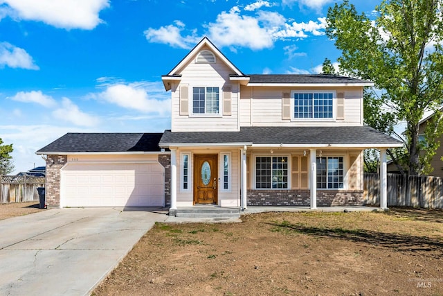 660 Teton, Mountain Home, ID 83647 - traditional-style home featuring an attached garage, concrete driveway, a porch, and fence