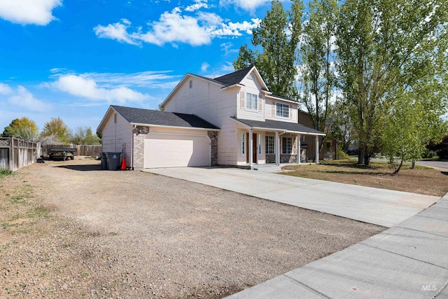 660 Teton, Mountain Home, ID 83647 - view of front of house with brick siding, fence, an attached garage, concrete driveway, and a porch