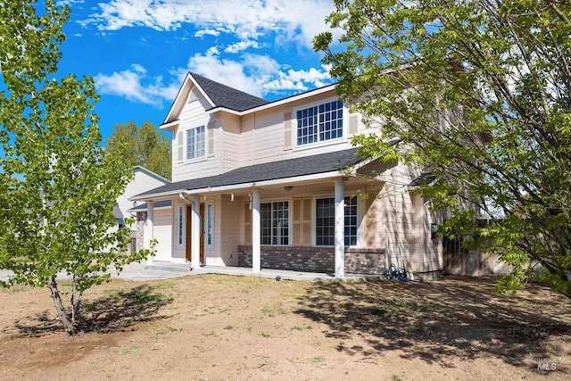 660 Teton, Mountain Home, ID 83647 - traditional-style house featuring covered porch, a shingled roof, and brick siding