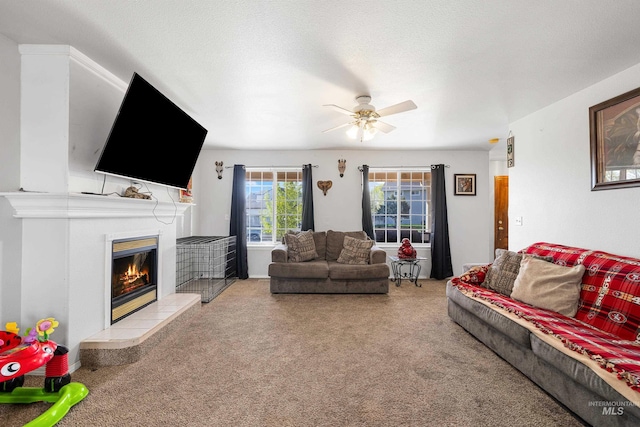 660 Teton, Mountain Home, ID 83647 - living room with carpet, a tiled fireplace, and ceiling fan