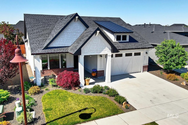 view of front facade featuring brick siding, driveway, a garage, roof with shingles, and a front yard