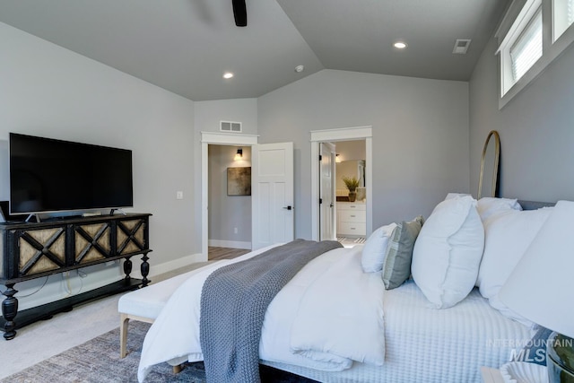bedroom featuring vaulted ceiling, carpet, connected bathroom, baseboards, and ceiling fan