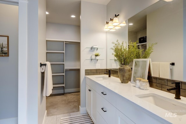 full bathroom featuring recessed lighting, double vanity, baseboards, and tile patterned floors