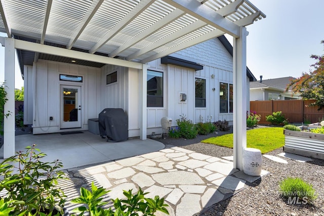 view of patio with fence, a pergola, and area for grilling