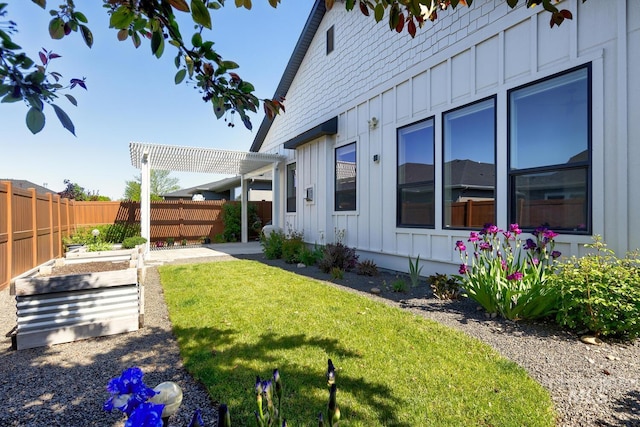 view of yard with a garden, a pergola, and a patio area