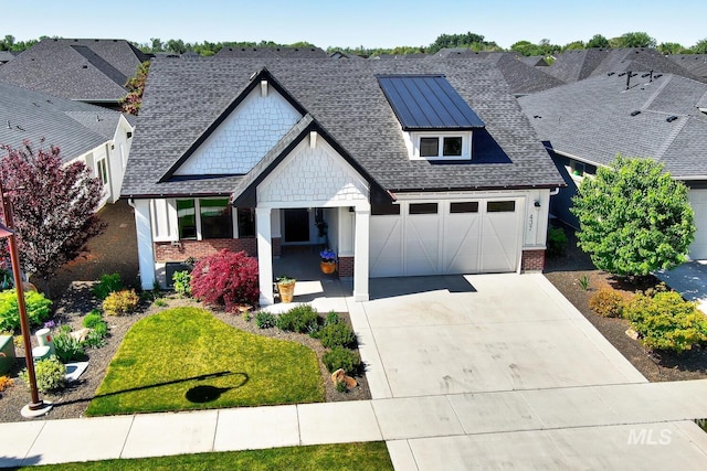 craftsman-style home featuring brick siding, concrete driveway, a shingled roof, and a residential view