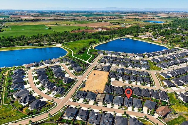 aerial view of property's location with a large body of water and nearby suburban area