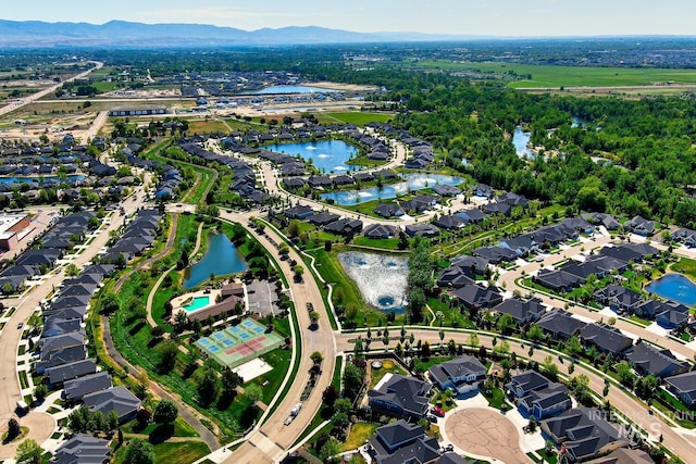aerial view of property's location featuring a water and mountain view and nearby suburban area