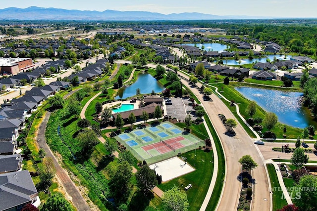 aerial view of property's location with nearby suburban area and a water and mountain view