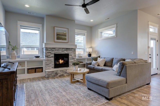living area featuring wood finished floors, plenty of natural light, a ceiling fan, and recessed lighting