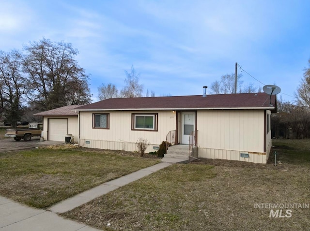 view of front of home with a front yard, a garage, and central AC unit