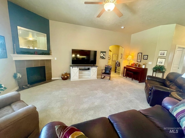 719 W Arbor Pointe, Nampa, ID 83686 - carpeted living room with arched walkways, a ceiling fan, a fireplace, and a textured ceiling