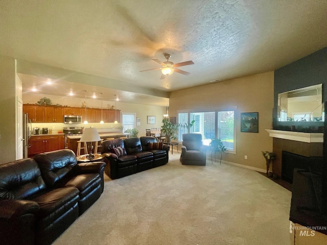 719 W Arbor Pointe, Nampa, ID 83686 - living room with a ceiling fan, light carpet, a fireplace with flush hearth, and a textured ceiling