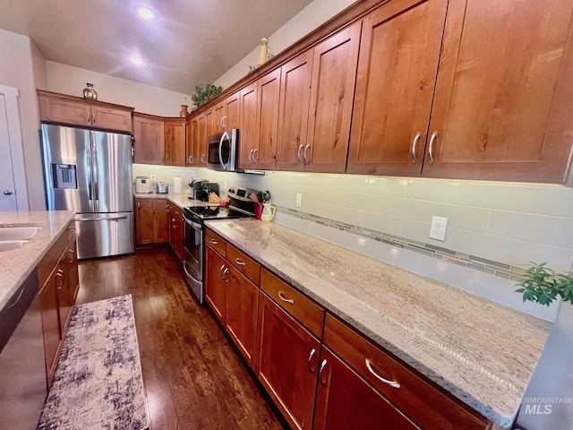 719 W Arbor Pointe, Nampa, ID 83686 - kitchen featuring stainless steel appliances, dark wood-style flooring, backsplash, and light stone counters