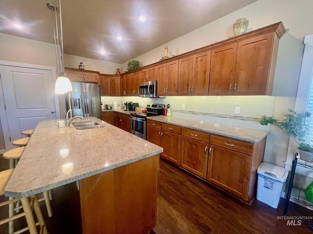 719 W Arbor Pointe, Nampa, ID 83686 - kitchen featuring appliances with stainless steel finishes, dark wood-style flooring, brown cabinetry, and light stone countertops