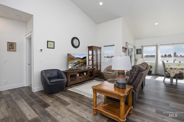 living area with dark wood-style floors, high vaulted ceiling, recessed lighting, and baseboards