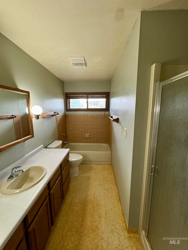 full bathroom featuring vanity, toilet, and separate shower and tub