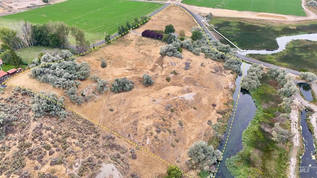 drone / aerial view with a water view and a rural view