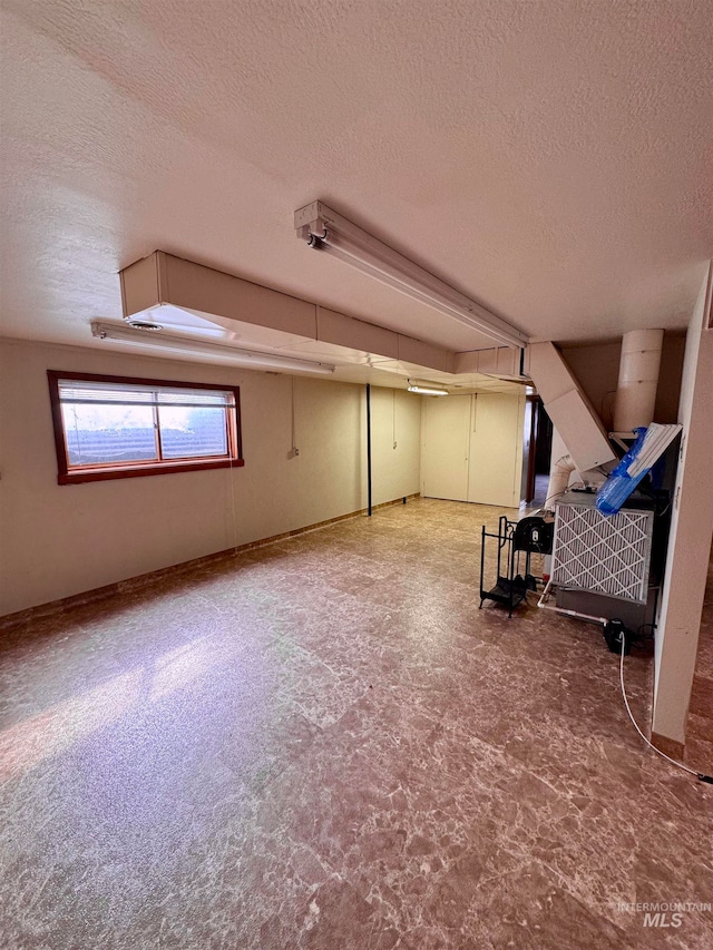 bonus room featuring a textured ceiling