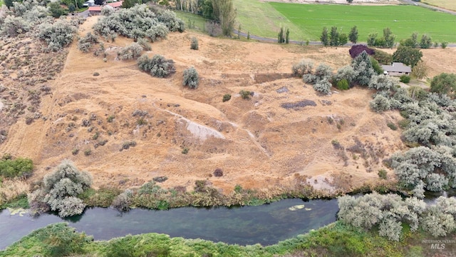 birds eye view of property featuring a rural view and a water view