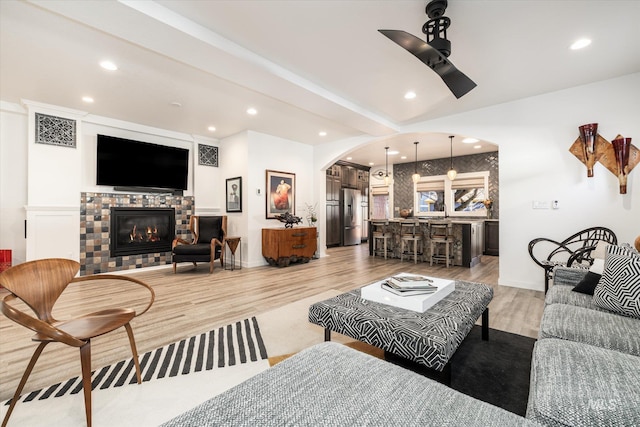 living room featuring ceiling fan and light hardwood / wood-style flooring