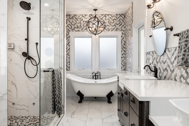 bathroom featuring an inviting chandelier, separate shower and tub, and vanity