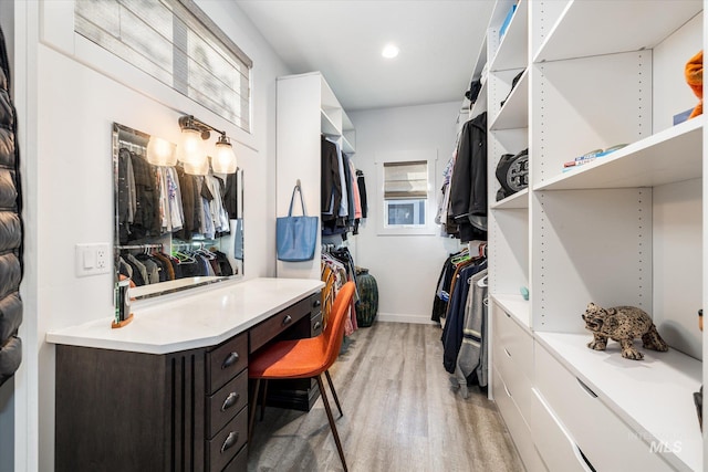 spacious closet with light hardwood / wood-style flooring