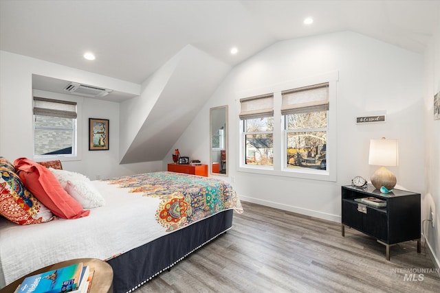 bedroom featuring lofted ceiling and hardwood / wood-style flooring