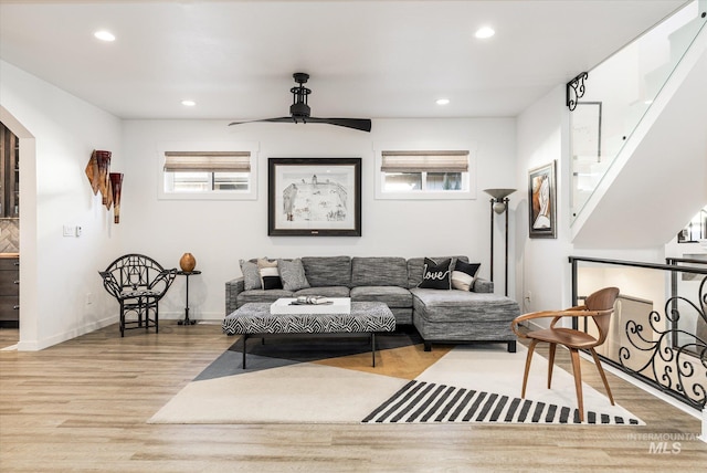 living room featuring ceiling fan and light hardwood / wood-style flooring