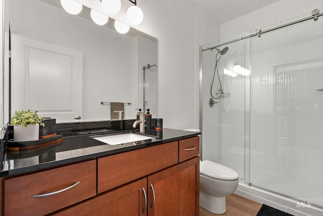 851 W Front St Unit 607, Boise, ID 83702 - full bath featuring a shower stall, toilet, vanity, and wood finished floors
