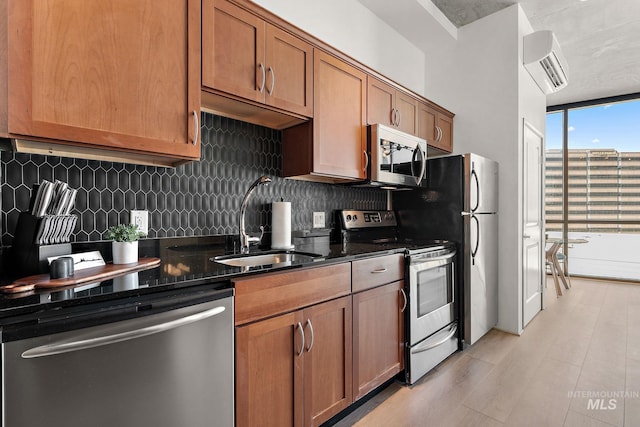 851 W Front St Unit 607, Boise, ID 83702 - kitchen with appliances with stainless steel finishes, backsplash, a sink, a wall unit AC, and floor to ceiling windows