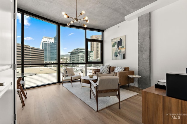 851 W Front St Unit 607, Boise, ID 83702 - living area with a wall of windows, wood finished floors, a chandelier, and a city view