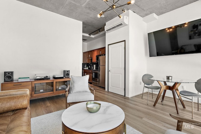 851 W Front St Unit 607, Boise, ID 83702 - living room with wood finished floors, a wall mounted AC, and a chandelier