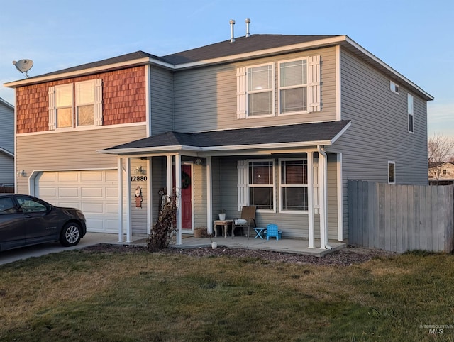 view of front of house with a garage, a front lawn, and a porch