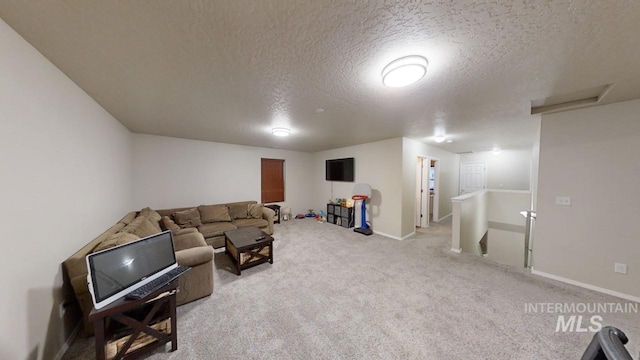 carpeted living room featuring a textured ceiling