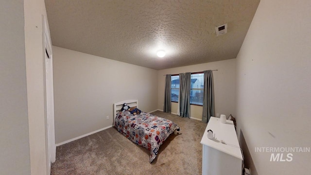 bedroom featuring carpet floors and a textured ceiling