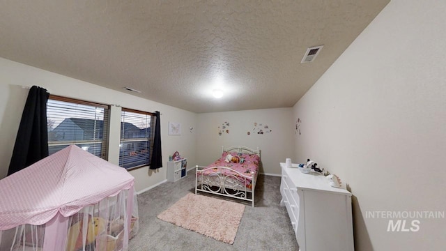 carpeted bedroom with a textured ceiling