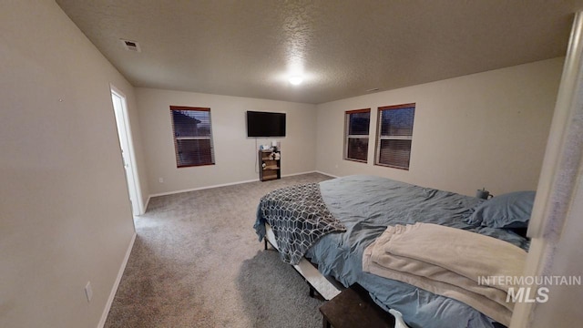 carpeted bedroom featuring a textured ceiling