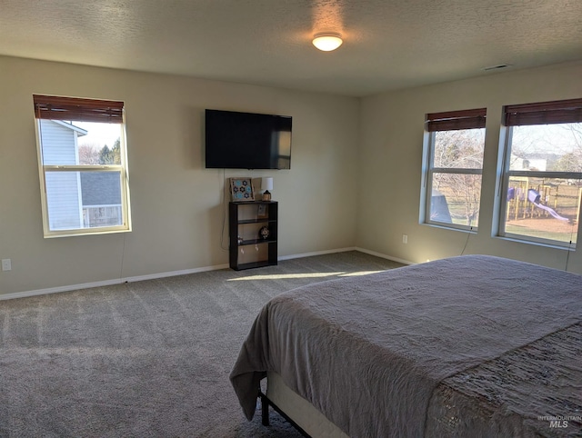 bedroom featuring carpet and a textured ceiling