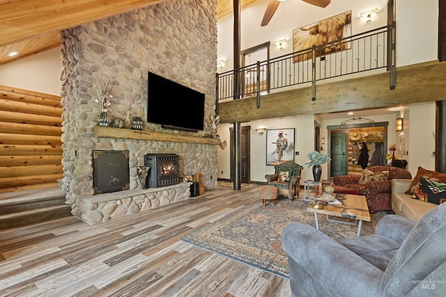 14051 Deerfield Rd, Mccall, ID 83638 - living room with high vaulted ceiling, ceiling fan, a stone fireplace, wood finished floors, and stairs