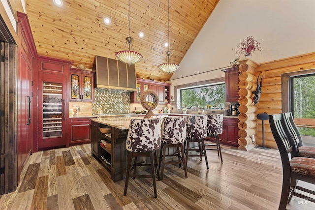 14051 Deerfield Rd, Mccall, ID 83638 - kitchen with open shelves, premium range hood, wine cooler, high vaulted ceiling, and wood finished floors